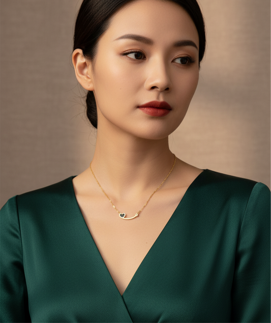 Gold Curved Bar Necklace with Black Heart Charm